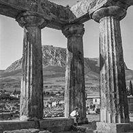 Corinth 1961.  Charles McCabe at the Temple of Apollo.  Acrocorinth in background. 