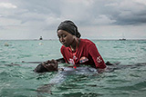 Swim instructor Siti, 24, helps a girl float in the Indian Ocean off of Nungwi, Zanzibar, 2017