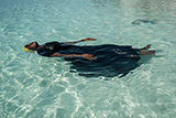 A young woman learns to float in the Indian Ocean off of Nungwi, Zanzibar, 2017