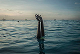 Swim instructor Chema, 17, snaps her fingers as she disappears underwater in Nungwi, Zanzibar, 2017