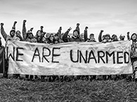 Banner that was hung at Oceti Sakowin Camp to remind law enforcement the camp was non-violent and was also carried during actions and marches through North Dakota during the Standing Rock movement, September 21, 2017