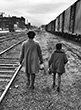 Linda Brown, who was refused admission to a white elementary school, and her 6-yr-old sister Terry Lynn walking along railroad tracks to bus which will take them to segregated Monroe Elementary School during the landmark Brown vs. Board of Education case, Topeka, Kansas, 1953